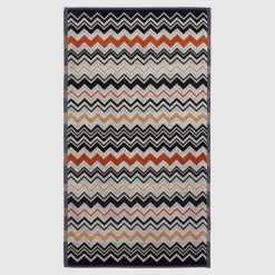 Asciugamano ospite Bernard in spugna di cotone a fantasia chevron bianco nero e coccio
