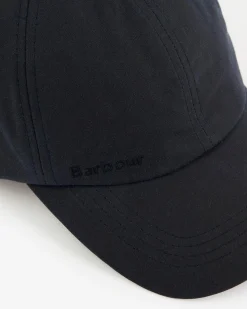 Berretto Barbour blu in cotone cerato con frontino