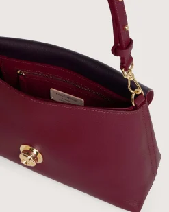 Borsa a mano bordeuax Coccinelle Nikla Small con patta e chiusura a girello con logo