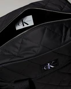 Borsa Calvin Klein nera in tessuto trapuntato con tracolla e fasciatoio portatile