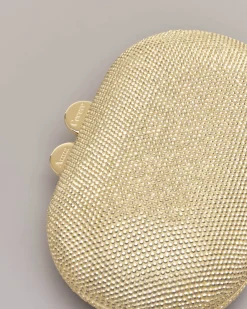 Clutch ovale color oro con strass applicati all over e chiusura a scatto a sfera