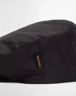 Coppola Barbour nera in cotone cerato con paraorecchie in tartan check