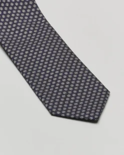 Cravatta blu in fantasia fiorellino grigio di misto seta e cotone