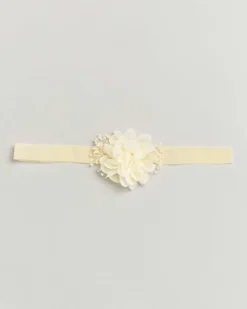 Fascetta color panna con fiore e decorazioni
