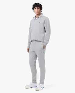 Pantaloni Lacoste grigi in felpa di cotone con logo coccodrillo verde sul fianco