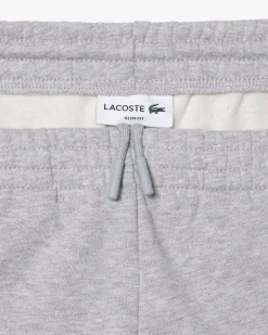 Pantaloni Lacoste grigi in felpa di cotone con logo coccodrillo verde sul fianco