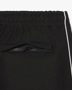 Pantaloni Lacoste neri in felpa piqué interlock di cotone con piping in contrasto