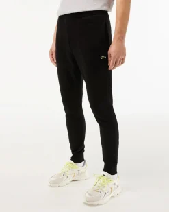 Pantaloni Lacoste neri in felpa di cotone con logo coccodrillo verde sul fianco