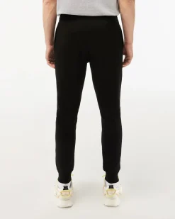 Pantaloni Lacoste neri in felpa di cotone con logo coccodrillo verde sul fianco