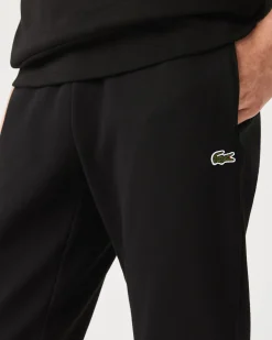 Pantaloni Lacoste neri in felpa di cotone con logo coccodrillo verde sul fianco