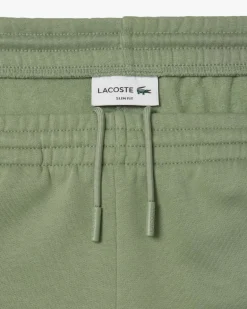 Pantaloni Lacoste verde salvia in felpa di cotone con logo coccodrillo verde sul fianco