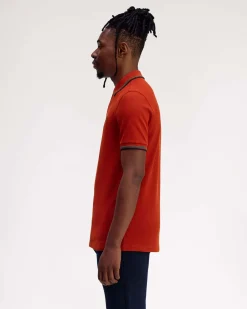 Polo Fred Perry arancione mezza manica con bordino verde acqua e blu