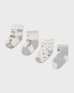 Set di quattro calze beige grigi e panna a fantasia animaletti in misto cotone stretch