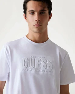 T-shirt Guess bianca in cotone con logo scritta in rilievo sul petto